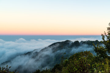 Panoramic view while morning mist covered partly mountain seen from the second highest peak mountain in Thailand, Doi Pha Hom Pok, Fang, Chiang Mai, Thailand.