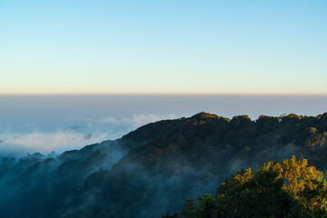 Panoramic view while morning mist covered partly mountain seen from the second highest peak mountain in Thailand, Doi Pha Hom Pok, Fang, Chiang Mai, Thailand.
