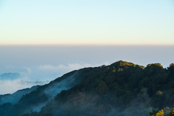 Panoramic view while morning mist covered partly mountain seen from the second highest peak mountain in Thailand, Doi Pha Hom Pok, Fang, Chiang Mai, Thailand.