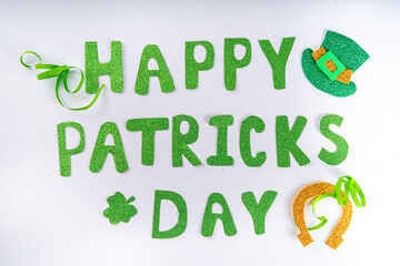 St Patrick flatlay background with shamrock clover leaves, leprechaun hat decor, golden coin, party...