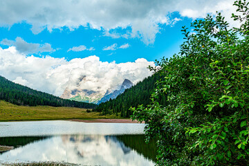 Reflection of mountains in Calaita lake Italy, Dolomites, Alps.