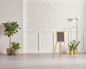 White classic and brick wall background concept, interior room, vase of green plant, black chair, frame, house appliance, marble floor.