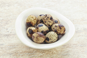 Raw quail eggs heap in the bowl