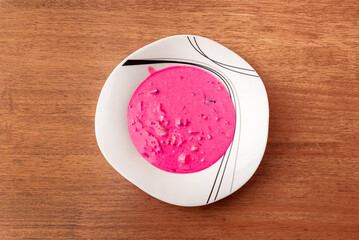 Cold soup with beet leaves served with egg.Traditional cold summer beetroot soup with vegetables in a white bowl.Saltibarscai,cold beet soup with kefir, lithuanian borscht.Summer cooking concept.