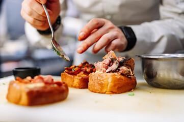chef hands cooking sandwich Set bruschetta on kitchen