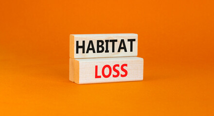 Habitat loss symbol. Concept words Habitat loss on wooden block. Beautiful orange table orange background. Business habitat loss concept. Copy space.