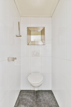 Interior of small restroom with wall mounted toilet