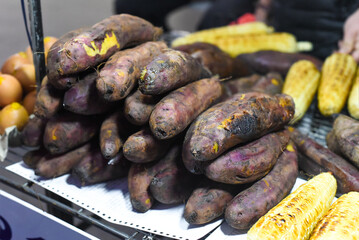 Grilled sweet potato and corn in vietnamese night market in Da Lat