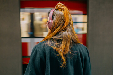 Portrait of a young woman from behind in the subway - moving train on the background