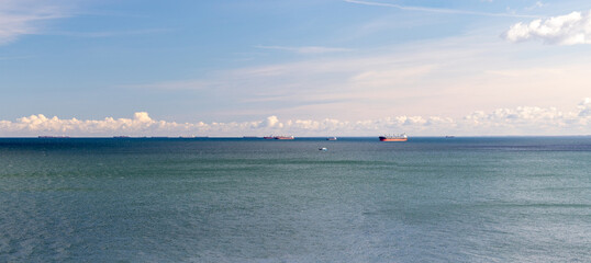 Beautiful sea panorama with cargo ships on the horizon.