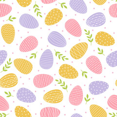 Seamless pattern with Easter decorated eggs. Yellow, pink and blue eggs and green branches on white background.