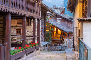 The rural architecture of Alagna village in the Valsesia valley range at dusk - Italy.
