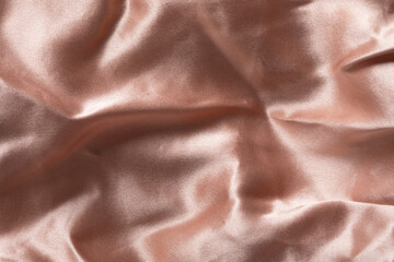 Smooth satin and silk pink fabric for backgrounds. Elegant abstract upholstery backdrop