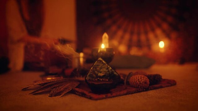 Cacao ceremony space, heart opening medicine. Burning incense at the altar with a labradorite and sitting woman in background.