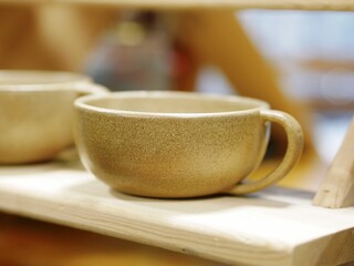 Fototapeta na wymiar Craft Ceramic Beige Mug Handmade Cup, selective focus, copy space 