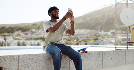Smartphone, selfie and black man on rooftop for cityscape photography with skateboard relax outdoor. Happy man using phone or cellphone for social networking skate update of location © Siphosethu F/peopleimages.com