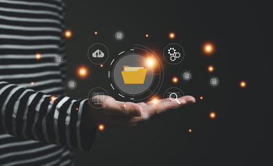 Selective focus at finger point at document icon at laptop computer that being share among working group on cloud storage platform. Technology that allow people to work remotely, online files.