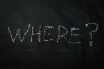 Obraz premium Where ? The word where written in chalk on a blackboard - one of the essential questions in journalism and communication