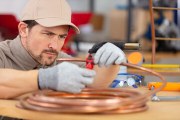 a cooper worler during pipes cutting