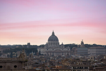 Fototapeta na wymiar Top view from Quirinale Palace of Rome with St Peter's Basilica (San Pietro) in Vatican City, Italy at sunset. It is a famous landmark of Vatican. Nice cityscape of the old Roma