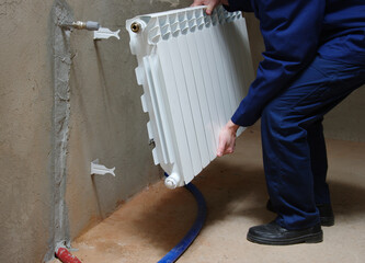 Plumber fixing a radiator