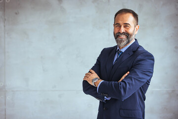 Portrait of a confident mature businessman working in a modern office. Mature cheerful executive businessman at workspace office. Portrait of smiling ceo at modern office workplace in suit - obrazy, fototapety, plakaty