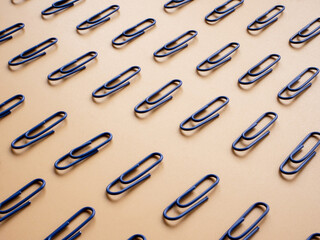 Abstract concept of order and uniformity in the form of rows of paper clips.
