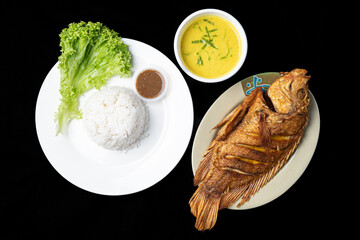 Fried Tilapia or Ikan Nila Goreng. Served on gulai lemak and rice.