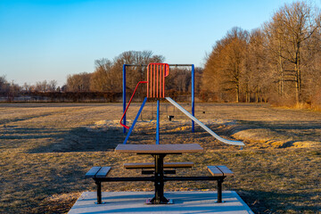 Lonely Slide in Playground during winter waiting for springtime for the children.