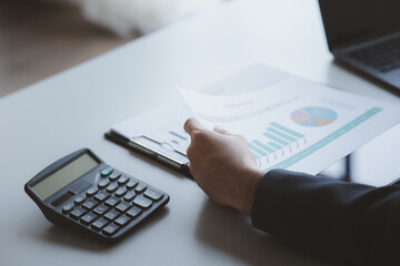 A business finance man is reviewing a company's financial documents prepared by the Finance Department for a meeting with business partners. Concept of validating the accuracy of financial numbers.