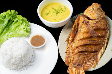 Fried Tilapia or Ikan Nila Goreng. Served on gulai lemak and rice.