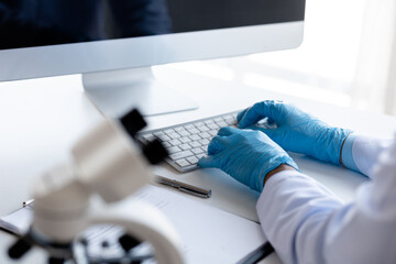 Lab practitioner working on chemical research for chemical reactions, does a chemical experiment and examines a patient's blood sample. Medicine and research concept.