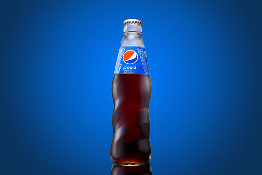 Zaporozhye, Ukraine - February 19, 2023: Pepsi bottle 0,33l on a blue background. Professional studio shot.