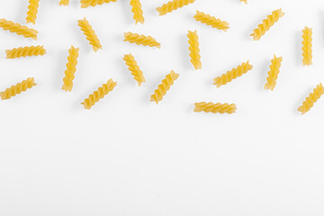 Pasta products in the form of a spiral, texture, on a white background