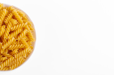 Pasta products in the form of a spiral on a plate, texture, on a white background