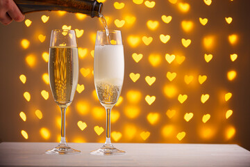 beautiful glasses of champagne on a blurred background of hearts