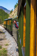 Sargan, Mokra Góra, Serbia - 29 April 2021: Tourists in the windows of moving Sargan Osmica (train)