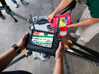 Agricultural drones are adding chemicals. Demonstration of drone remote control.