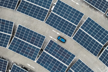 Aerial view of solar panels on a parking lot rooftop for electric car charging