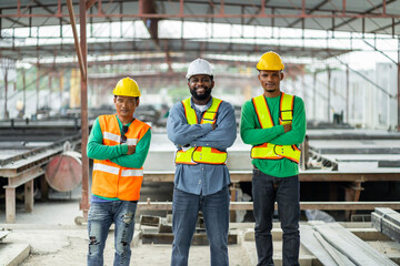 Male engineers are inspecting and controlling the work of the employees and the quality of the manufactured products to meet the standards In industrial factories producing precast prefabricated walls