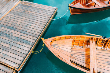 Fototapeta na wymiar Boats on the Braies Lake in Dolomites mountains, Sudtirol, Italy