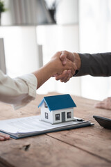 Sealing a deal. Asian people business real estate agent with client consulting and discussing at...