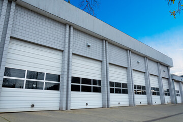 An image of a large delivery center with white bay doors. 