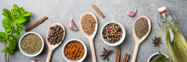 Fresh herbs and spices on gray stone table. Food background