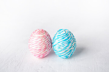 Easter minimal composition with eggs on a textured light background. Copy space.
