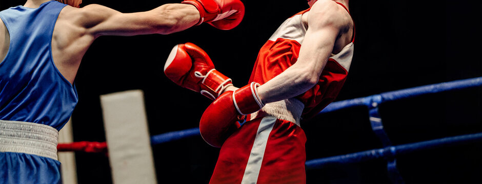 boxing match in ring boxer lands right jab to opponent