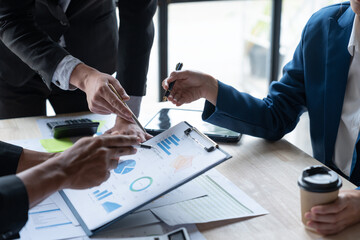 Asian business people brainstorming in a graph analytical computing plan meeting. data chart Marketing growth. Finance. The concept of business success statistics.