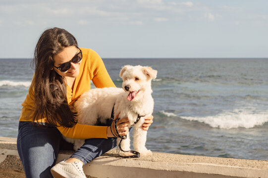 Young woman enjoying a walk with her dog, outdoor family