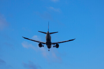 Commercial aircraft overflying the sky and arriving at airport