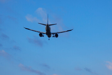 Commercial aircraft overflying the sky and arriving at airport